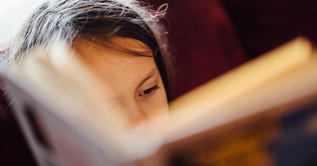 child reading a book featured